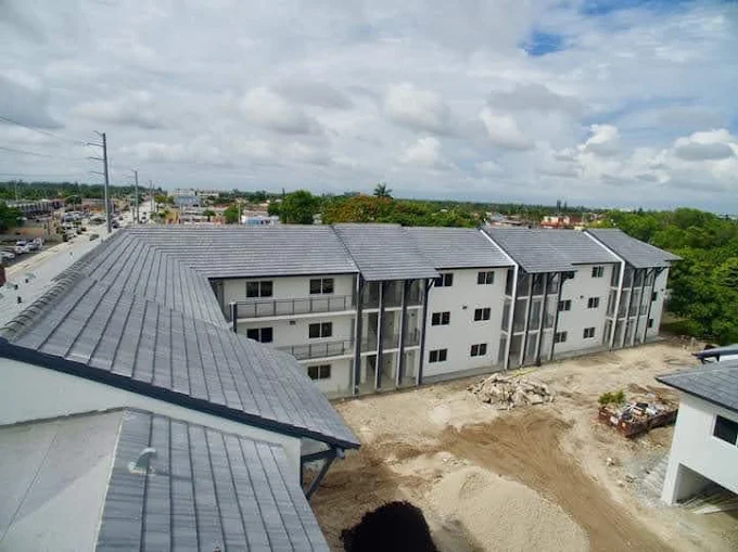 Multi-building roofing installation with grey metal roof panels